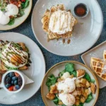 A cosy cafe table with fresh pancakes, coffee, and fruit served for breakfast
